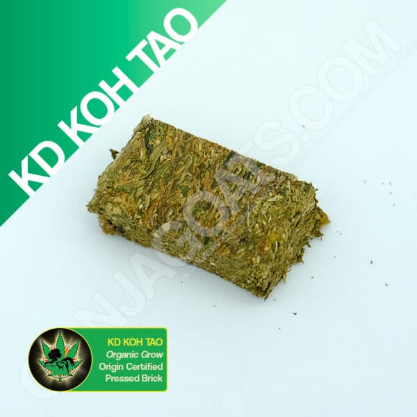 Close up photo of the pressed brick cannabis strain KD Koh Tao. Text next to the flower states the name of the strain, that it is organically grown, and pressed brick weed.